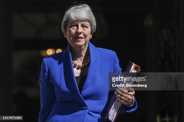 Theresa May, U.K. Prime minister, departs number 10 Downing Street to attend here final weekly questions and answers session in Parliament in London,...