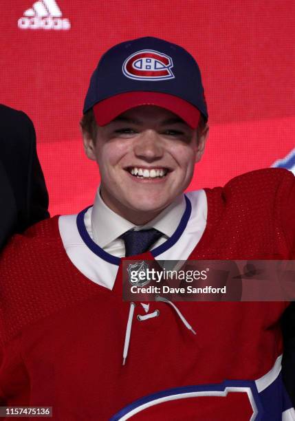 Cole Caufield, fifteenth overall pick of the Montreal Canadiens, poses for a photo onstage during the first round of the 2019 NHL Draft at Rogers...