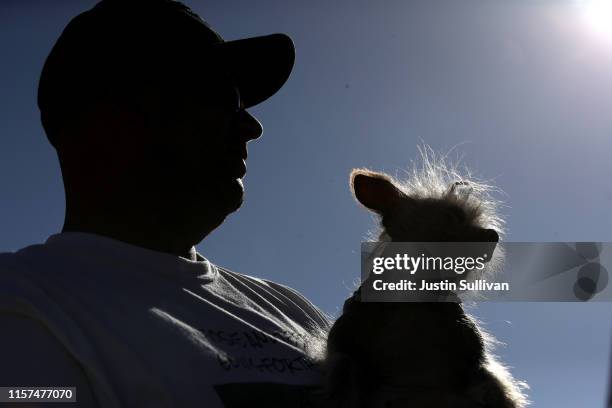 Contestant looks on with his dog before the start of the World's Ugliest Dog contest at the Marin-Sonoma County Fair on June 21, 2019 in Petaluma,...