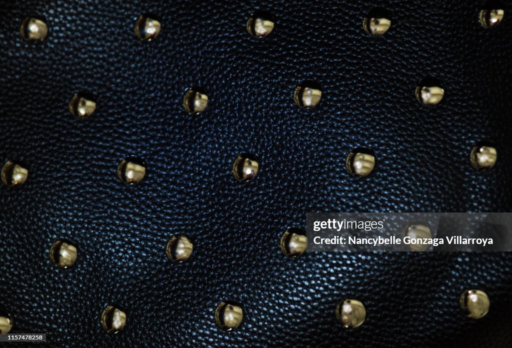 Black leather material with gold studs