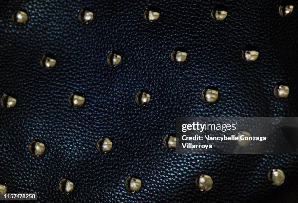 black leather material with gold studs - metallic purse stock pictures, royalty-free photos & images