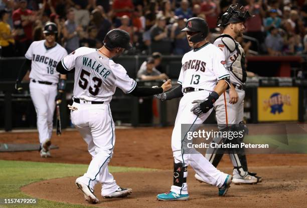 Nick Ahmed of the Arizona Diamondbacks celebrates with Christian Walker after hitting a two-run home run against the San Francisco Giants during the...