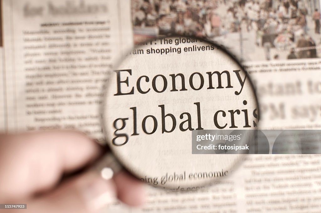 Magnifying glass over a newspaper highlighting words