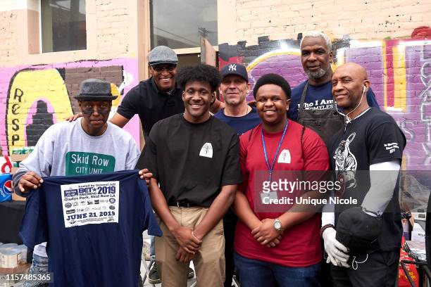 Charles Oakley and foundation volunteers attend The Help Give Care Foundation and the Charles Oakley Foundation host “Homeless But Human” Pop-up...