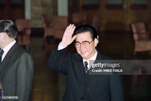 Chinese Prime Minister Li Peng waves farewell at the Great Hall of the People on January 26, 1992 in Beijing, China, prior to his departure for...