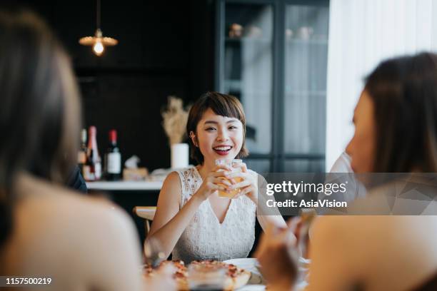 portrait of smiling young asian woman having fun and enjoying food and drinks in party with friends - eating yummy stock pictures, royalty-free photos & images