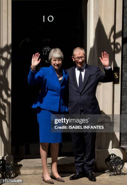 Britain's outgoing prime minister Theresa May, , accompanied by her husband Philip, gestures after making a speech outside 10 Downing street in...