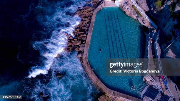 drone photo: bronte beach rock poll - bondi beach drone stock pictures, royalty-free photos & images