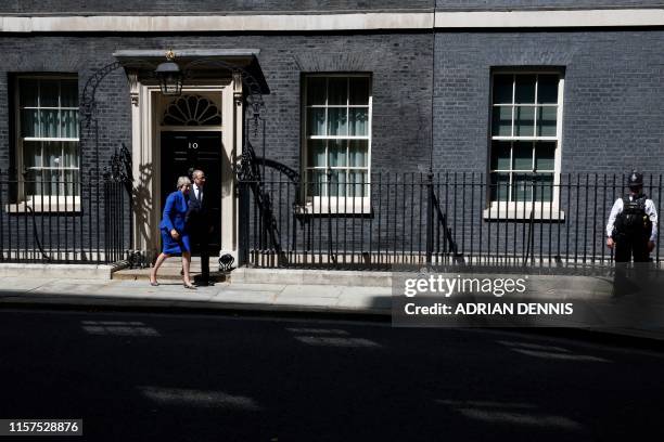 Britain's outgoing prime minister Theresa May,, accompanied by her husband Philip, leaves after making a speech outside 10 Downing street in London...