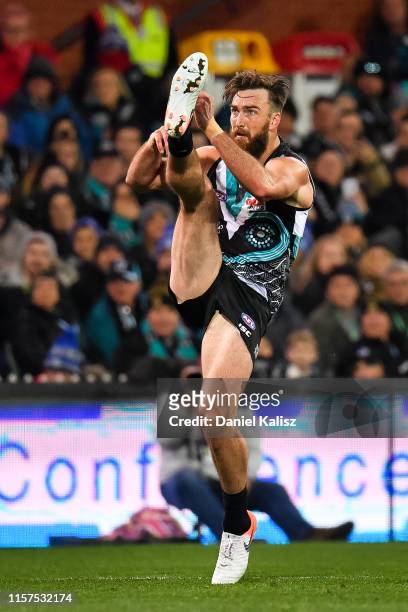 Charlie Dixon of the Power kicks the ball during the round 14 AFL match between the Port Adelaide Power and the Geelong Cats at Adelaide Oval on June...