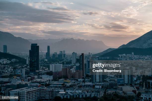 Buildings stand at dawn in Monterrey, Nuevo Leon state, Mexico, on Thursday, June 20, 2019. Coca Cola Co. Bought the rights to Topo Chico and its...