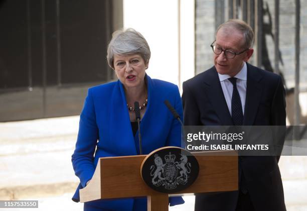 Britain's outgoing prime minister Theresa May, , accompanied by her husband Philip, gives a speech outside 10 Downing street in London on July 24,...
