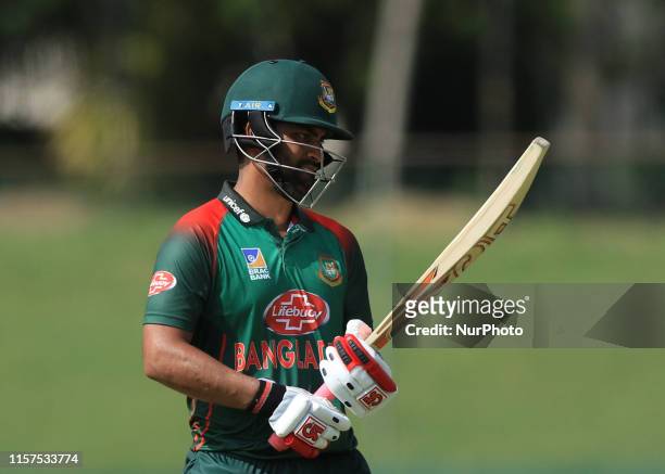 Bangladesh cricketer Tamim Iqbal walks back to pavilion following his dismissal during the tour match between Sri Lanka Board President's XI and...