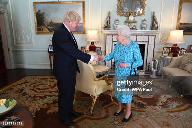 Queen Elizabeth II welcomes newly elected leader of the Conservative party, Boris Johnson during an audience where she invited him to become Prime...