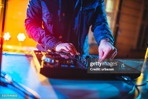 dj playing and mixing music at party - edm dj stock pictures, royalty-free photos & images