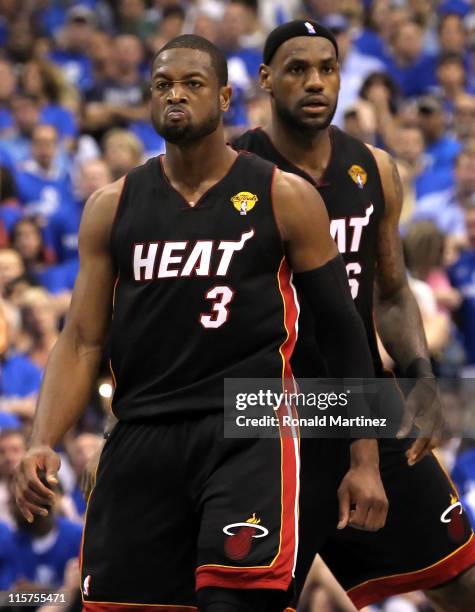 Dwyane Wade and LeBron James of the Miami Heat look on in the fourth quarter against the Dallas Mavericks in Game Five of the 2011 NBA Finals at...