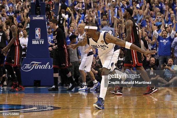 Jason Terry of the Dallas Mavericks reacts after he made a 3-point shot late in the fourth quarter as Udonis Haslem , Mike Miller and LeBron James of...