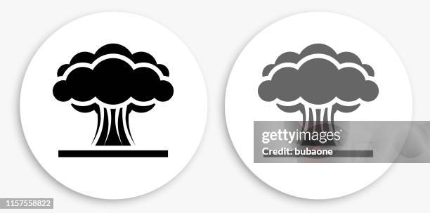atomic explosion black and white round icon - nuclear explosion icon stock illustrations