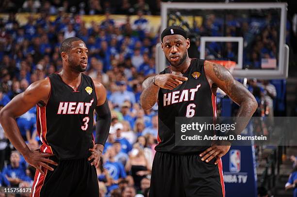 Dwyane Wade and LeBron James of the Miami Heat talk during a break in the action against the Dallas Mavericks during Game Five of the 2011 NBA Finals...