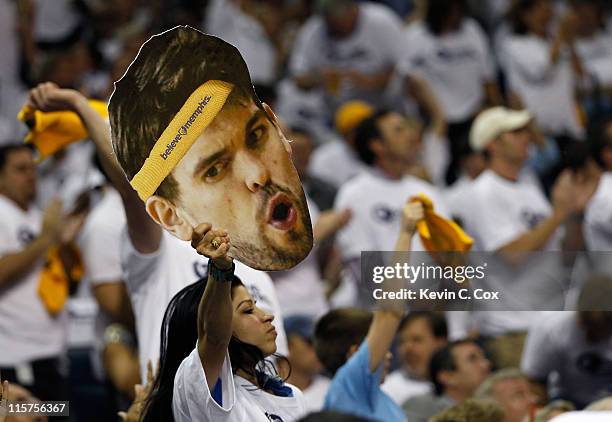 Fan holds up a picture of the face of Marc Gasol of the Memphis Grizzlies against the Oklahoma City Thunder in Game Six of the Western Conference...