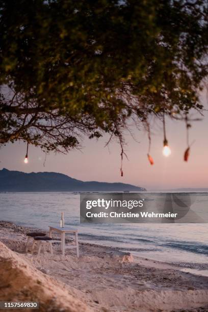 romantic sunset beachside view on gili trawangan - table for two stock pictures, royalty-free photos & images