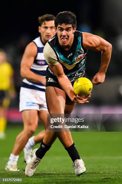 Joel Garner of the Power handballs during the round 14 AFL match between the Port Adelaide Power and the Geelong Cats at Adelaide Oval on June 22,...