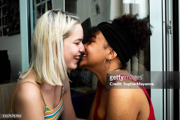 LGBT couple leaning in close and laughing