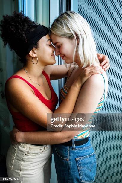 LGBT couple leaning in close and hugging