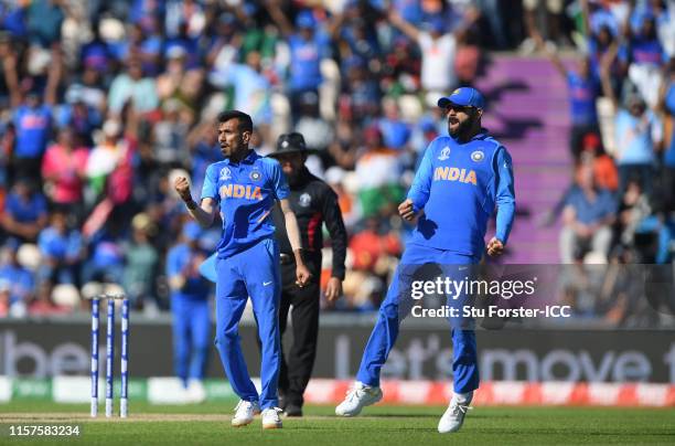 India bowler Yuzvendra Chahal celebrates with captain Virat Kohli after bowling Afghanistan batsman Ashgar during the Group Stage match of the ICC...