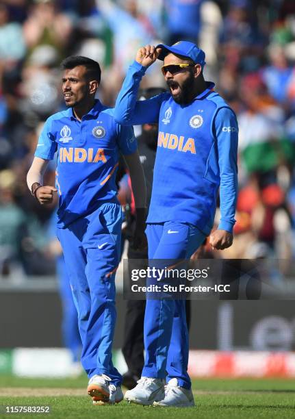 India bowler Yuzvendra Chahal celebrates with captain Virat Kohli after bowling Afghanistan batsman Ashgar during the Group Stage match of the ICC...