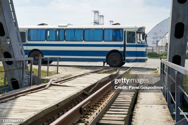 a local bus in front of the new safe confinement (nsc) of the chernobyl nuclear power plant, ukraine - nsc stock pictures, royalty-free photos & images