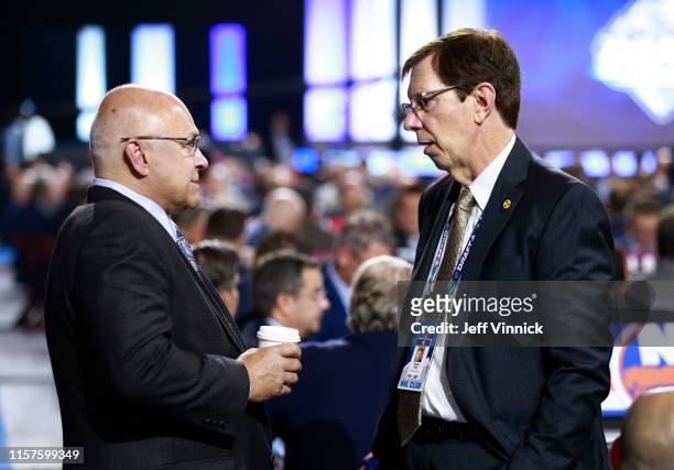 Head coach Barry Trotz of the New York Islanders and general manager David Poile of the Nashville Predators talk on the draft floor during Rounds 2-7...