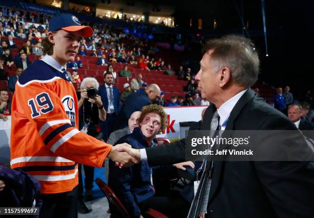 Raphael Lavoie, 38th overall pick of the Edmonton Oilers, is greeted by head coach Ken Holland of the Edmonton Oilers during Rounds 2-7 of the 2019...