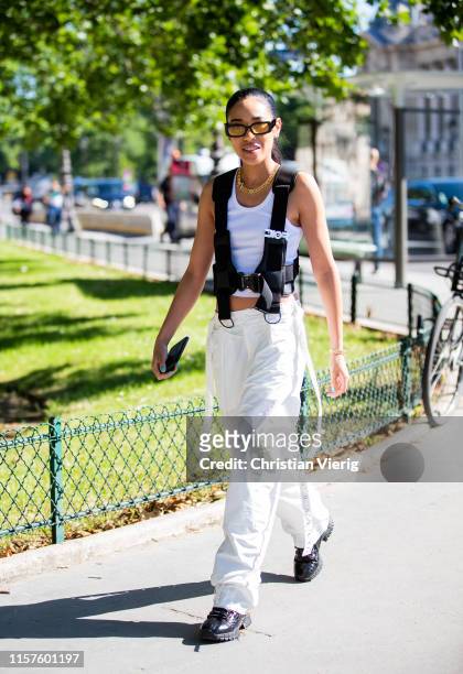 Aleali May is seen wearing white pants, cropped top, vest outside Sacai during Paris Fashion Week - Menswear Spring/Summer 2020 on June 22, 2019 in...