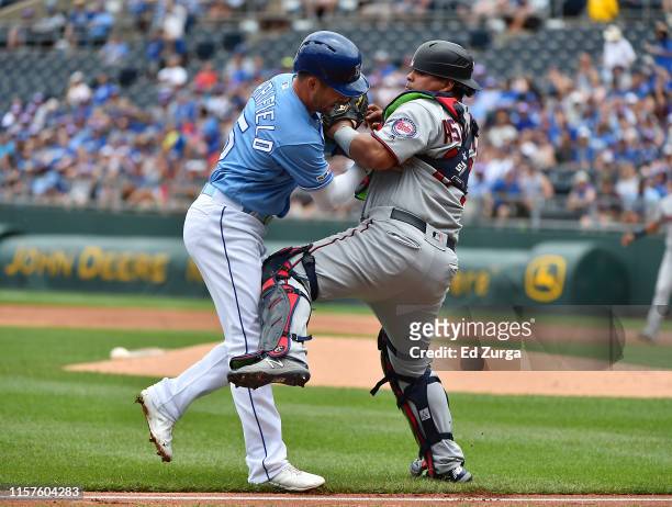 Whit Merrifield of the Kansas City Royals is tagged out by catcher Willians Astudillo of the Minnesota Twins during a rundown in the first inning at...