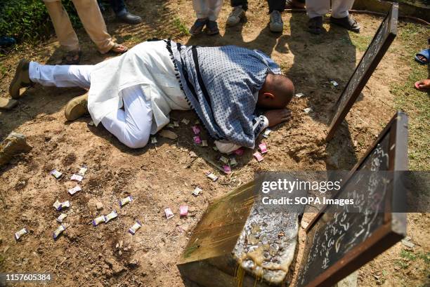 Mohammad Ali Bhat breaks down on the grave of his mother and father after his release in Srinagar. Ali lost both of his parents, mother and father...