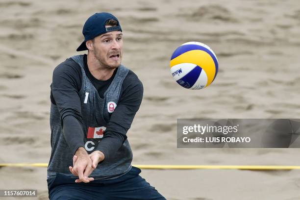 Canada's Aaron Nusbaum eyes the ball during a Lima 2019 Pan-American Games men's beach volleyball match against Nicaragua at the Beach Volleyball...