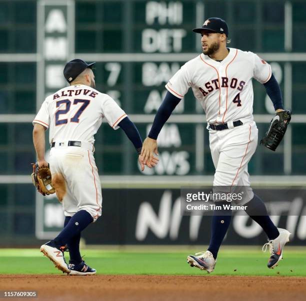 Jose Altuve of the Houston Astros celebrates with George Springer after the game against the Oakland Athletics at Minute Maid Park on July 24, 2019...