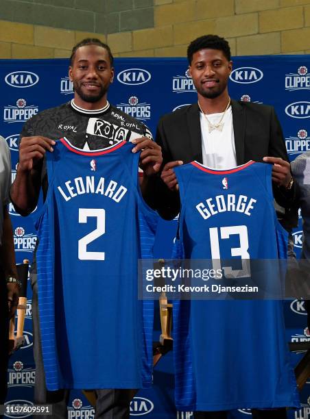 Kawhi Leonard and Paul George pose after a news conference where both players were introduced as new Los Angeles Clippers at Green Meadows Recreation...