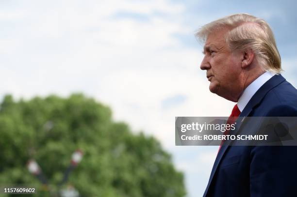 President Donald Trump pauses as he speaks to members of the press prior to departing from the South Lawn of the White House in Washington, DC, July...