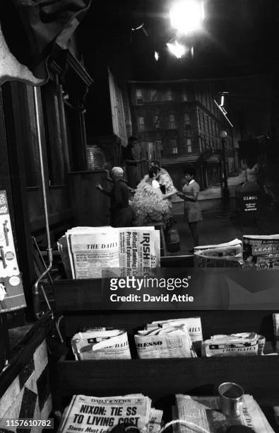 Puppeteer Caroll Spinney in his 'Big Bird' costume talks to actress Loretta Long as actor Matt Robinson reads a newspaper during the taping of an...