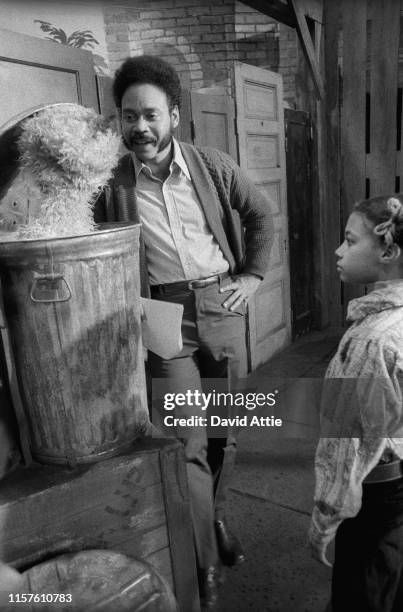 Actor Matt Robinson talks to muppet Oscar the Grouch as a child looks on during the taping of an episode of Sesame Street at Reeves TeleTape Studio...