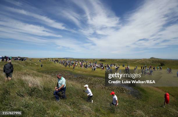 Crowds walk on the golf course during the finals during day six of the R&A Amateur Championship at Portmarnock Golf Club on June 22, 2019 in...