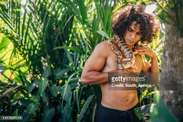 man holding snake - tarzan stock pictures, royalty-free photos & images