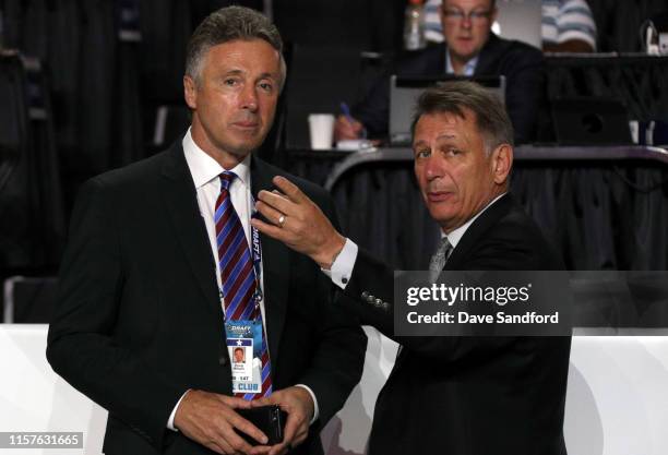 General manager Doug Wilson of the San Jose Sharks and general manager Ken Holland of the Edmonton Oilers talk on the draft floor during Rounds 2-7...