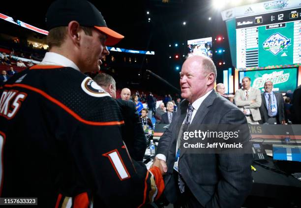 William Francis, 163rd overall pick of the Anaheim Ducks, is greeted by general manager Bob Murray on the draft floor during Rounds 2-7 of the 2019...