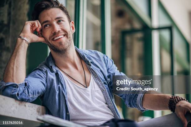 man in coffee shop - denim shirt stock pictures, royalty-free photos & images