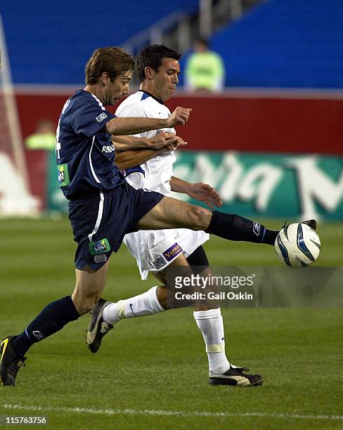 New England Revolution midfielder Steve Ralston fights for the ball with San Jose Earthquakes midfielder Ian Russell during the soccer game at...