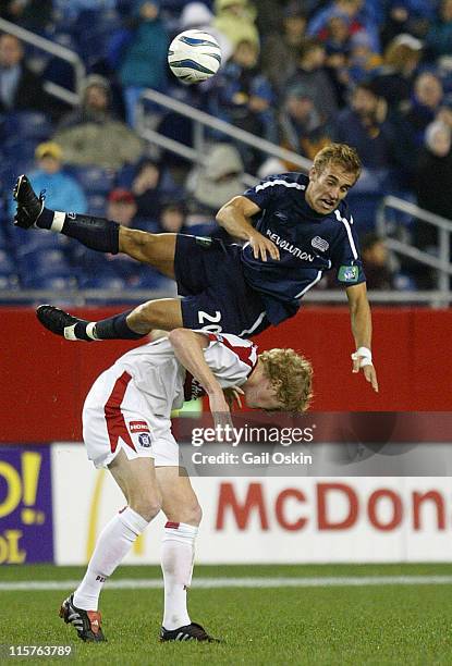 New England Revolution Taylor Twellman is upended over Chicago Fire Jim Curtin during the second half at Gillette Stadium in Foxborough...