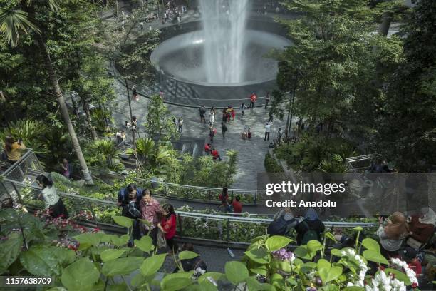 Visitors tour around the HSBC Rain Vortex, the worlds tallest indoor waterfall, at Jewel Changi Airport in Changi, Singapore on July 21, 2019.